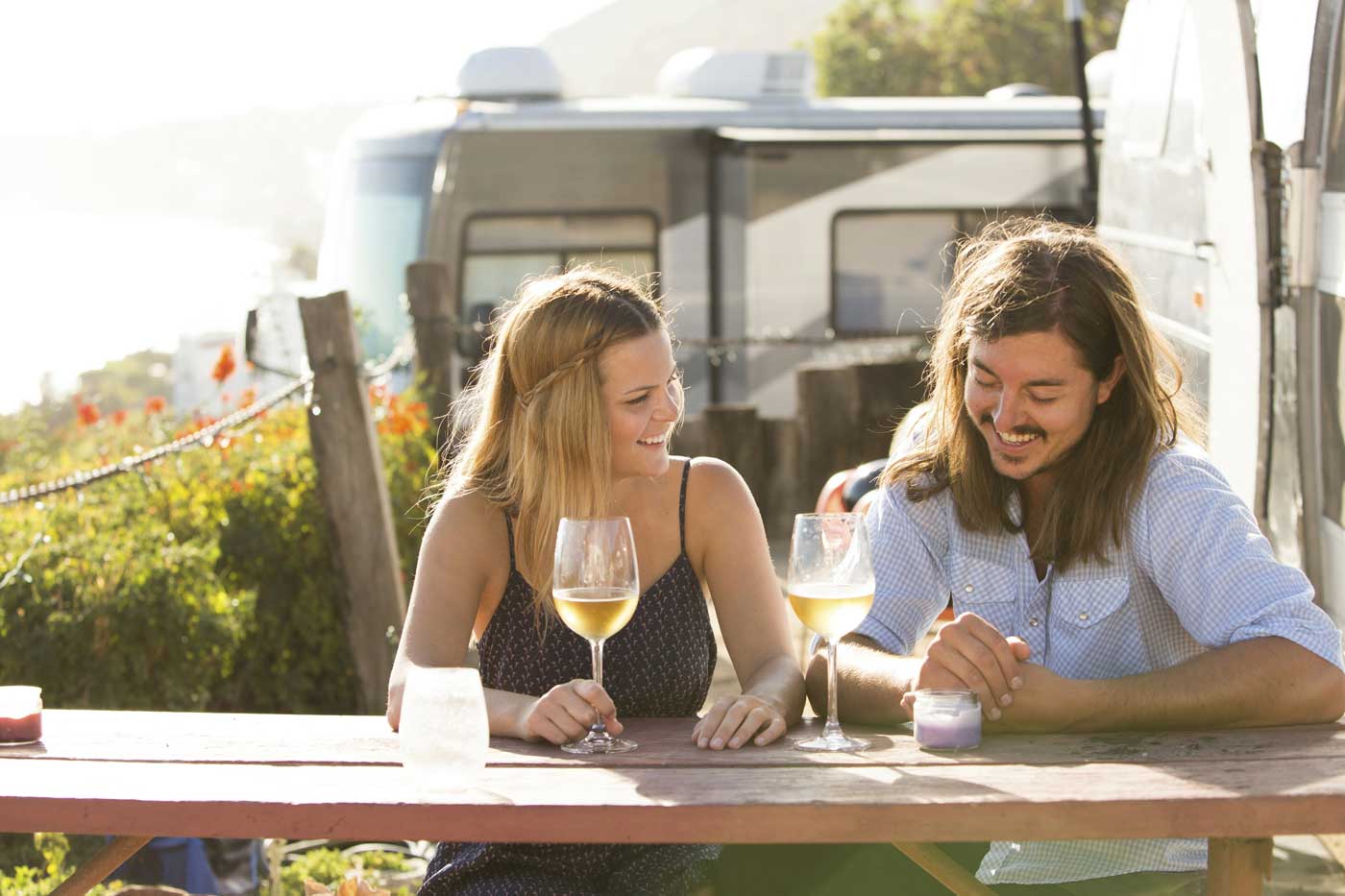 Couple sitting together at a picnic table at a campground