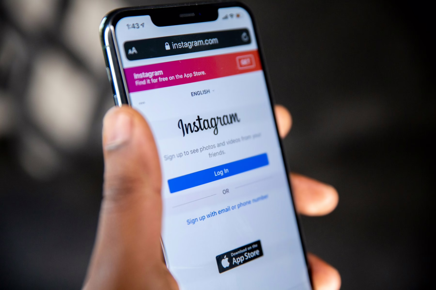 holding an iphone with instagram